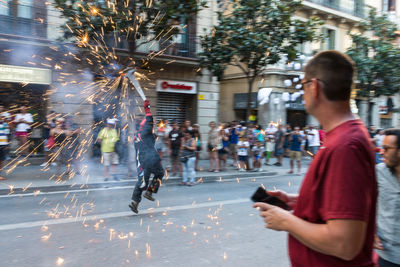 Man using mobile phone on street in city