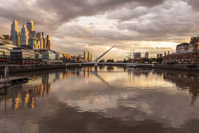 Beautiful sunset view to modern bridge and buildings in puerto madero