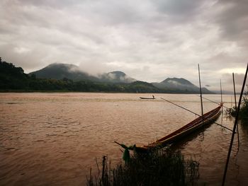 Scenic view of lake against cloudy sky