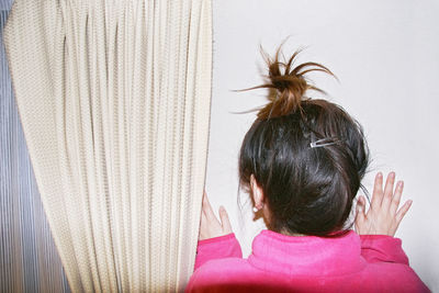 Rear view of woman at home