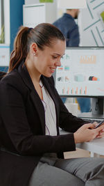 Businesswoman using laptop at office