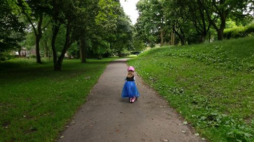 Full length of people walking on footpath