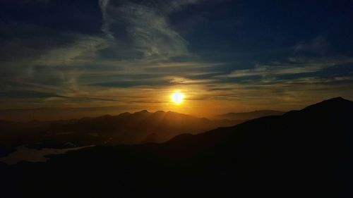 Scenic view of mountains against sky at sunset