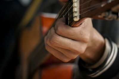 Cropped image of man playing guitar