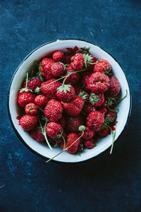 High angle view of strawberries in bowl on table
