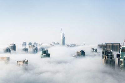 Buildings in city against clear sky