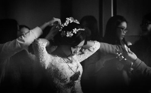 Midsection of couple holding flowers