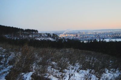 Scenic view of field against clear sky during winter