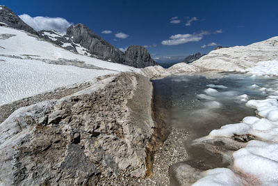 Scenic view of river and mountains against sky