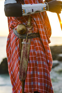 Close up of maasai warrior with a traditional knife attached to a belt