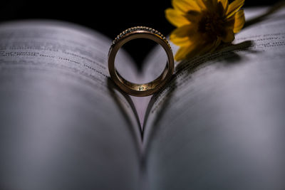 Close-up of wedding rings on book