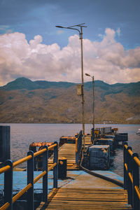 Pier by sea against sky