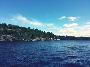 Scenic view of sea against blue sky