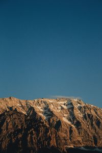 Low angle view of rock formations against clear blue sky