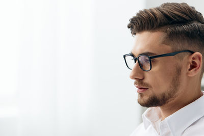 Close-up of young man looking away