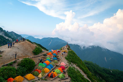 High angle view of cross on mountain against sky