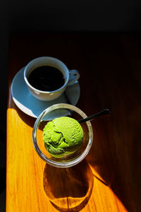 High angle view of coffee and green tea ice cream on table