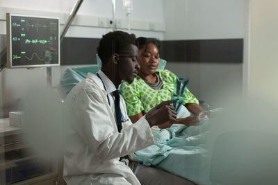 Doctor showing x ray to patient at clinic