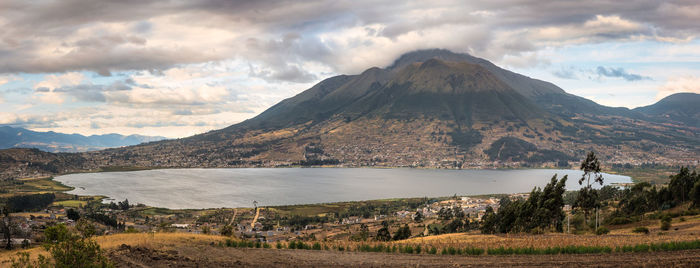 Scenic view of land and mountains against sky