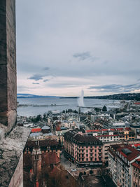 High angle view of buildings and lake against sky