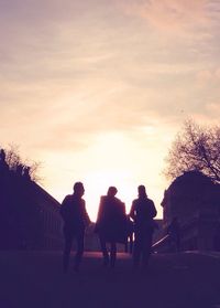 Silhouette of people at sunset