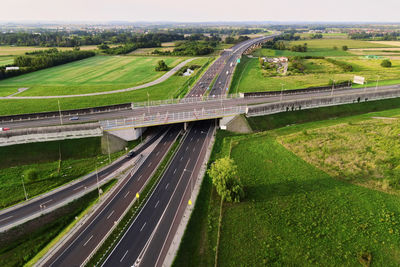 Cars moving on transport road junction in city, aerial view