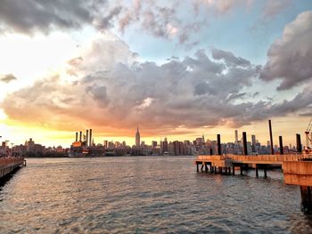 Scenic view of river against dramatic sky
