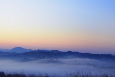 Scenic view of landscape against clear sky during sunset