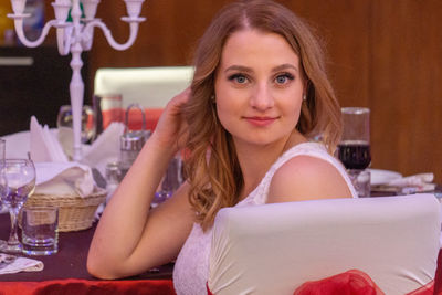 Portrait of smiling woman sitting in restaurant