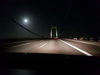 Illuminated street lights seen through car windshield