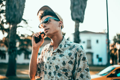 Man talking on phone while standing in city