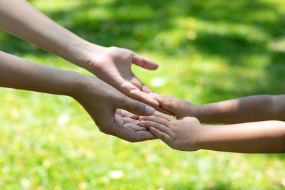 Cropped image of couple holding hands