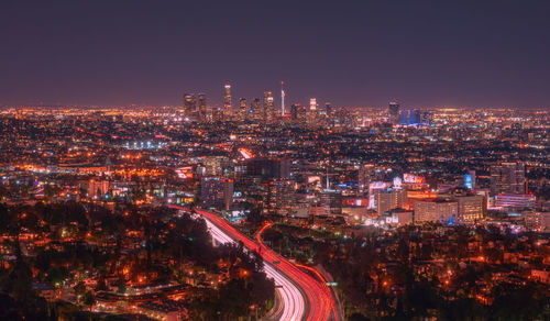 High angle view of illuminated city against sky at night