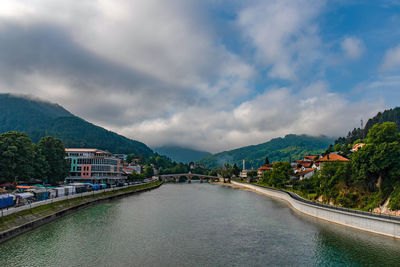 River amidst buildings against sky