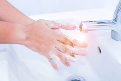 Close-up of woman hand with text in water