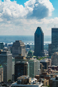 Cityscape by sea against sky