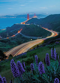 High angle view of road amidst land and mountains against sky