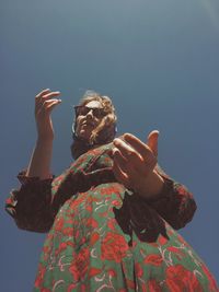 Low angle view of man standing against sky