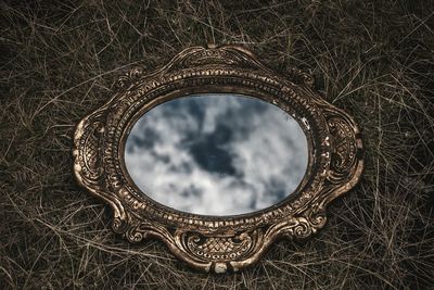 Close-up of metallic structure on field against sky