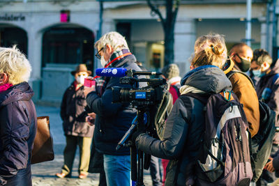 Rear view of people photographing