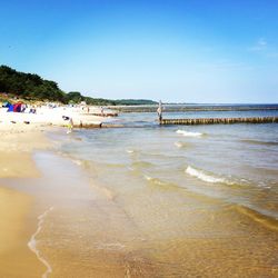 Scenic view of beach against blue sky