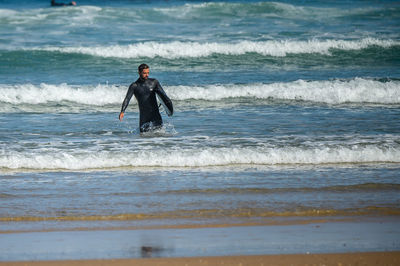 Full length of man standing on sea shore