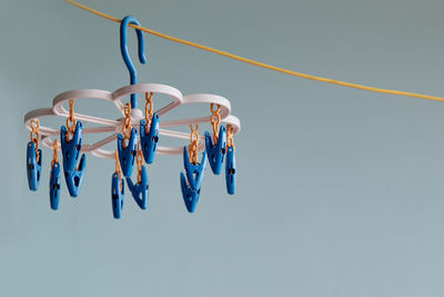 Low angle view of multi colored clothespins on clothesline