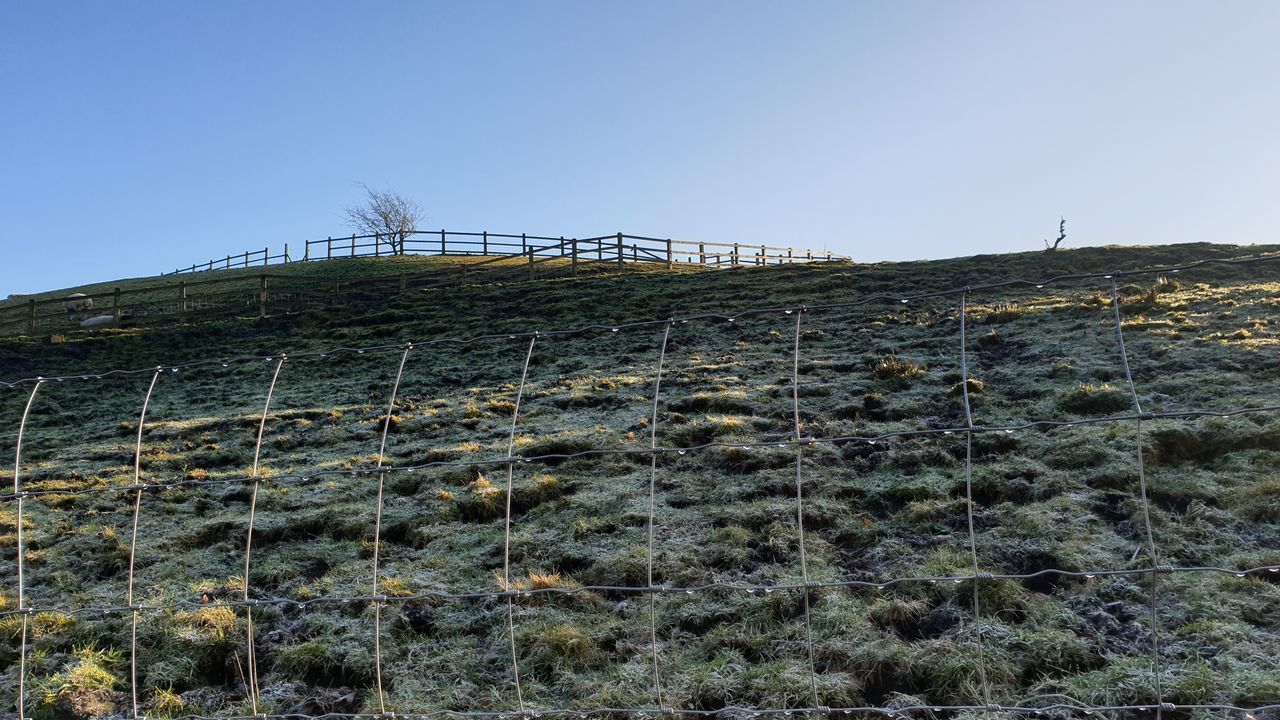 FENCE ON LANDSCAPE AGAINST CLEAR SKY