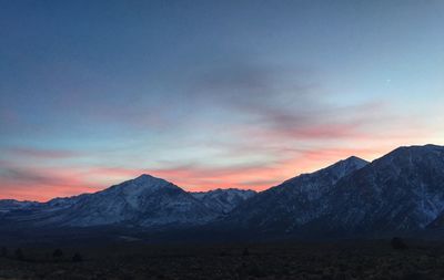 Scenic view of mountains against cloudy sky