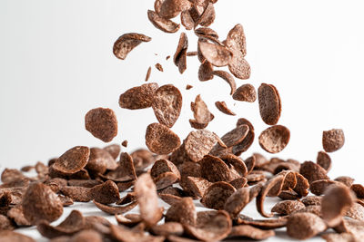 Close-up of coffee beans against white background