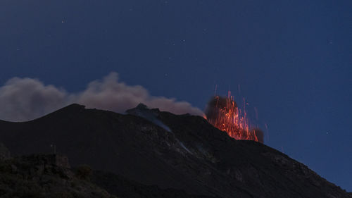 Scenic view of mountains against sky at night