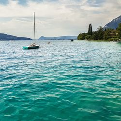 Sailboat sailing on sea against sky