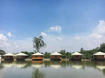 Scenic view of lake by building against sky