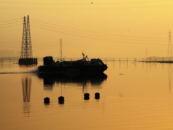 Scenic view of river against sky during sunset